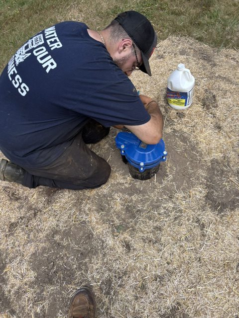 Greco & Haines technician inspecting a residential wellhead