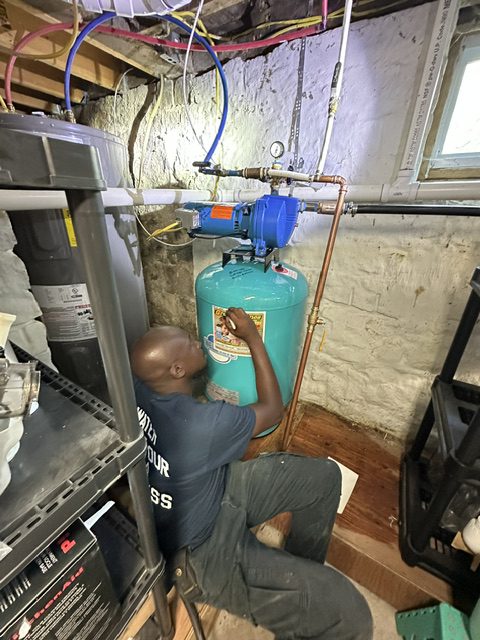 Greco & Haines technician installing a shallow-well jet pump and pressure tank